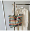 Blue straw woven shoulder bag with single strap showing textured exterior
