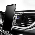 A matte black universal car phone holder mounted on a car air vent, showing the adjustable arm and phone grip.