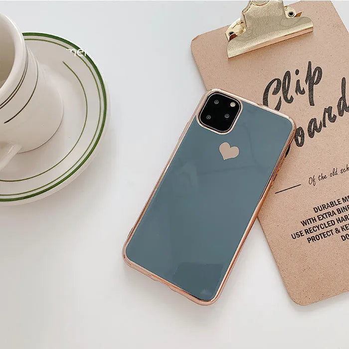Simple solid colour TPU back cover case for iPhone on a table, shown in blue.