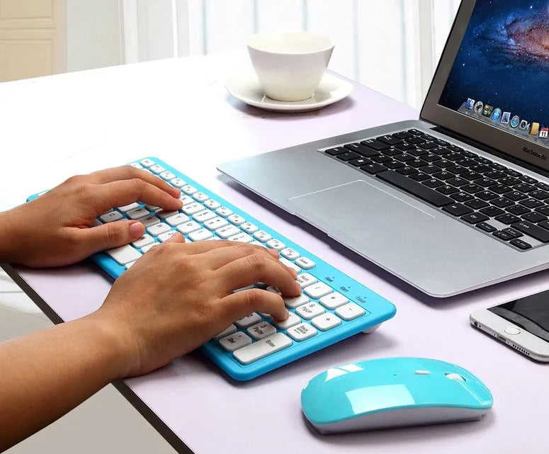 Black wireless keyboard and mouse set on a desk showing 96-key layout and compact mouse.