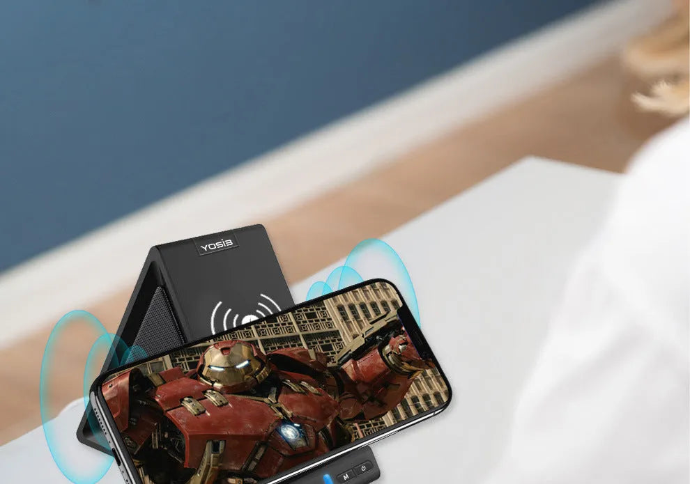 Black multifunctional Bluetooth speaker with integrated phone stand and wireless charging pad showing 165mm length