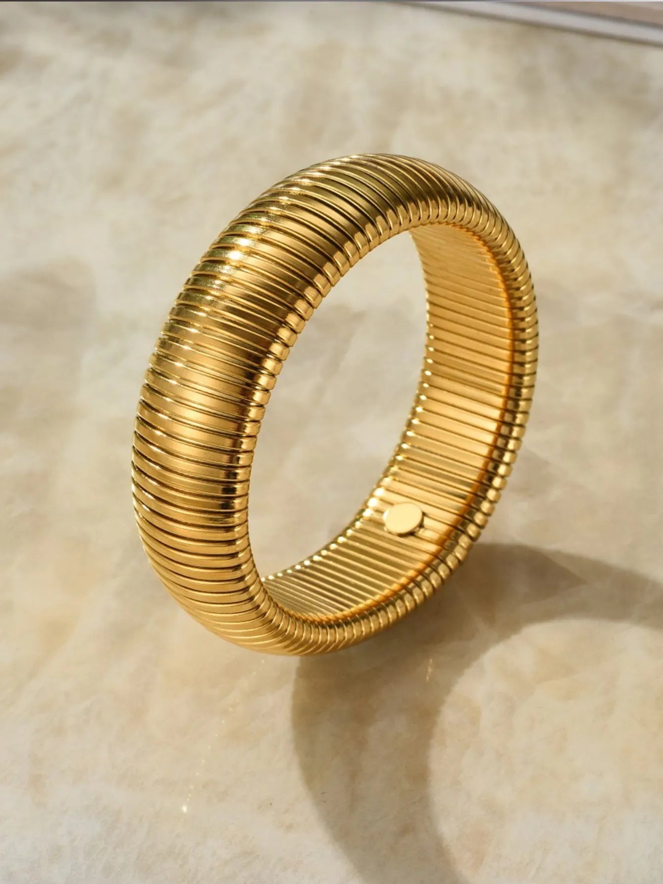 Gold titanium steel women's bracelet with elastic band and vertical stripe ring pattern, shown at 2cm width.