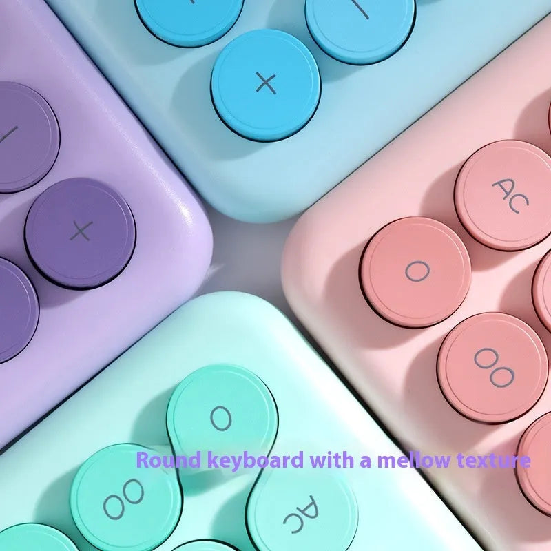 Violet, blue, green, and pink gradient colour desktop calculator on a desk.