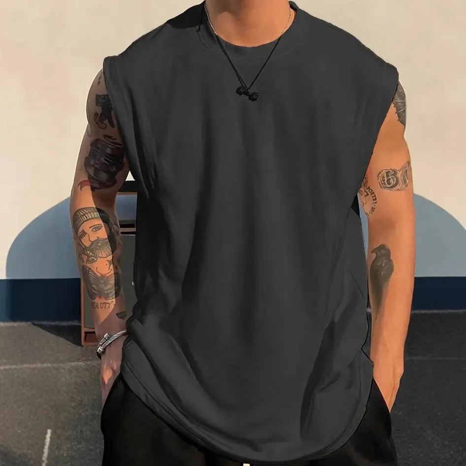 Men's loose cotton tank top in dark grey showing straight hem design and sleeveless construction