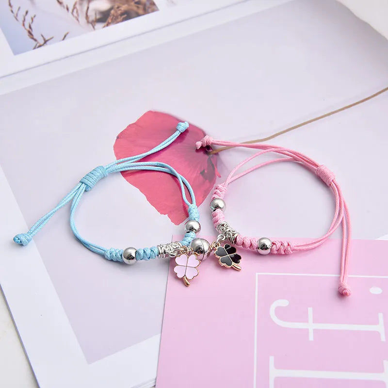 Alloy couple bracelets with magnet closure showing various design options including crown, clover, and text patterns