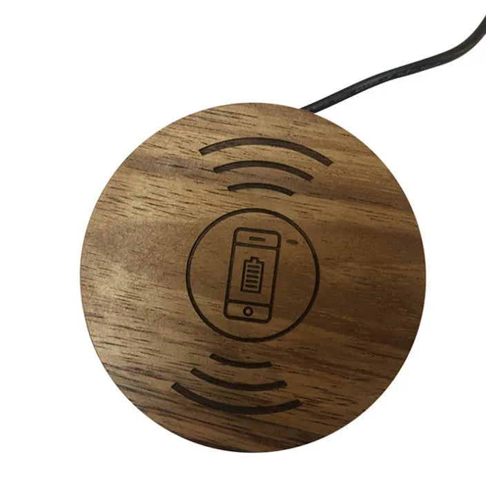 Round hidden wireless charger for embedding in desks, compatible with iPhone and Samsung phones.