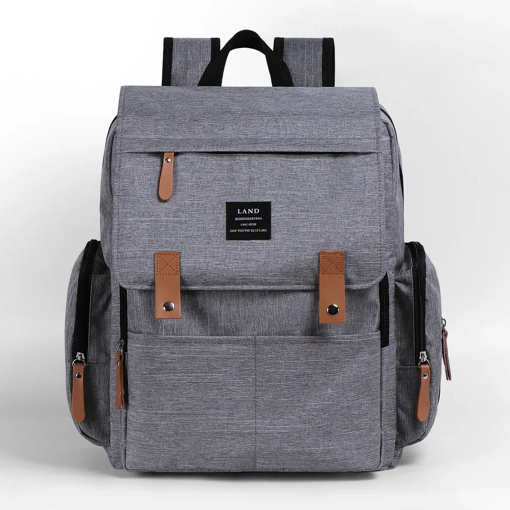 LAND Mommy large grey Oxford cloth diaper backpack with changing mat, showing front compartments.