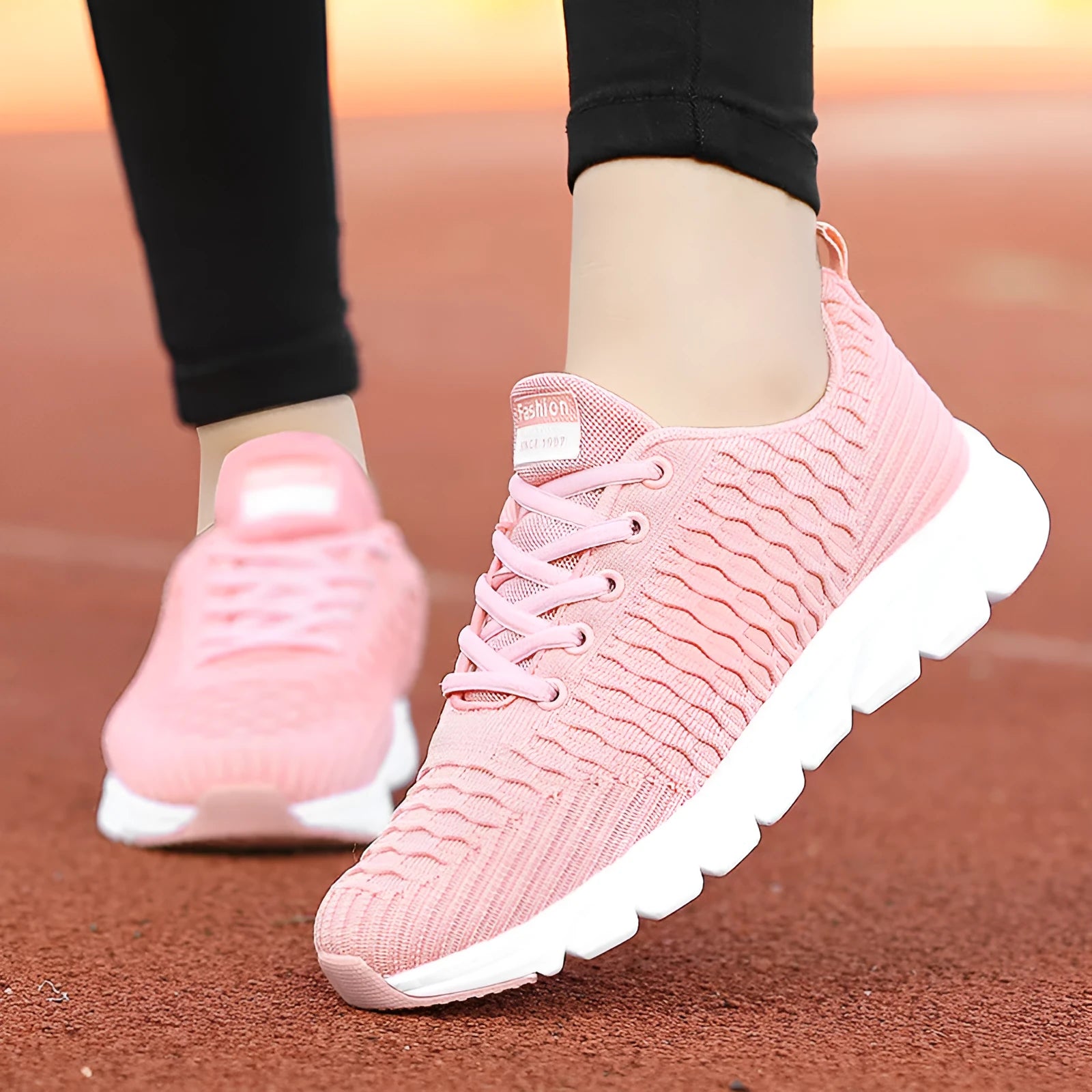 Women's running shoes in black, pink, or white with a breathable fly weave upper and wear-resistant outsole.
