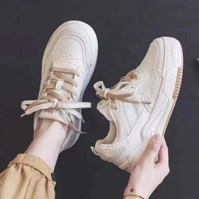 Women's pink and white low-top sneaker with rubber sole for height increasing