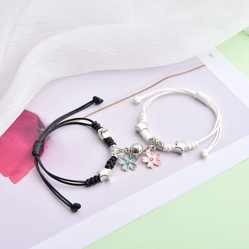 Alloy couple bracelets with magnet closure showing various design options including crown, clover, and text patterns