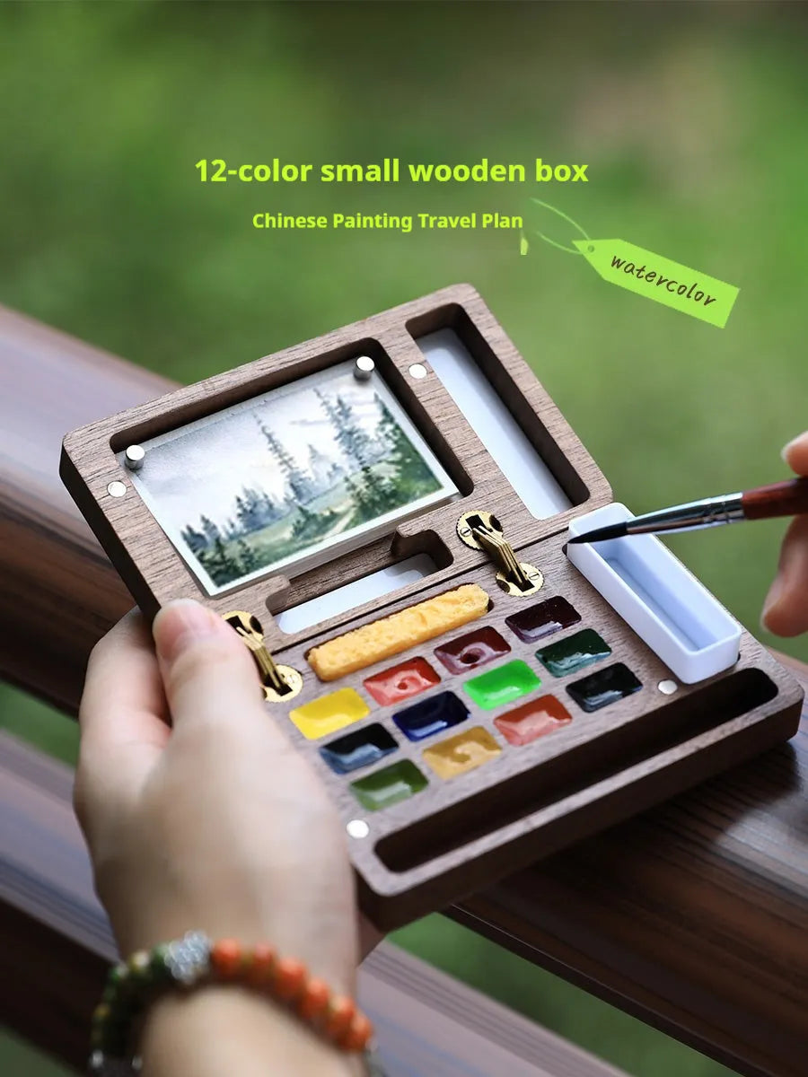 Mini wooden walnut watercolour paint box open showing pigment pans with choice of Schmincke, Holbein, Picasso, or Moonlight colour sets.