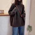 Women's loose-fit turtleneck sweater with a thick, textured curling pile collar in a grey solid colour.