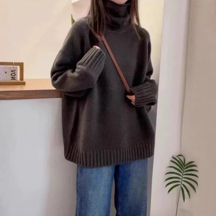 Women's loose-fit turtleneck sweater with a thick, textured curling pile collar in a grey solid colour.