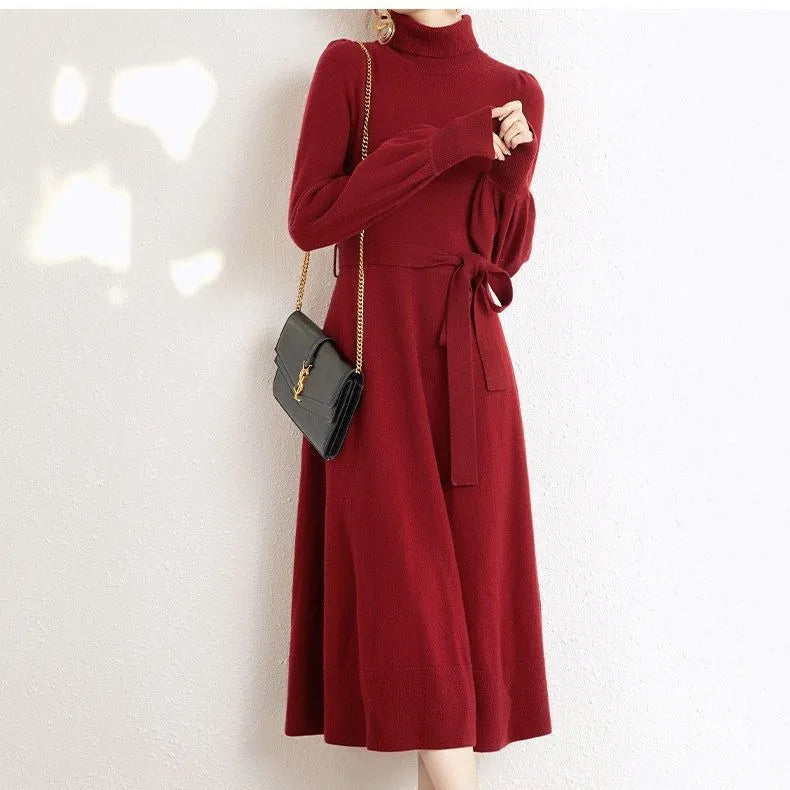 A rose red loose-fit turtleneck knit dress for women with long sleeves and a mid-length flared skirt.