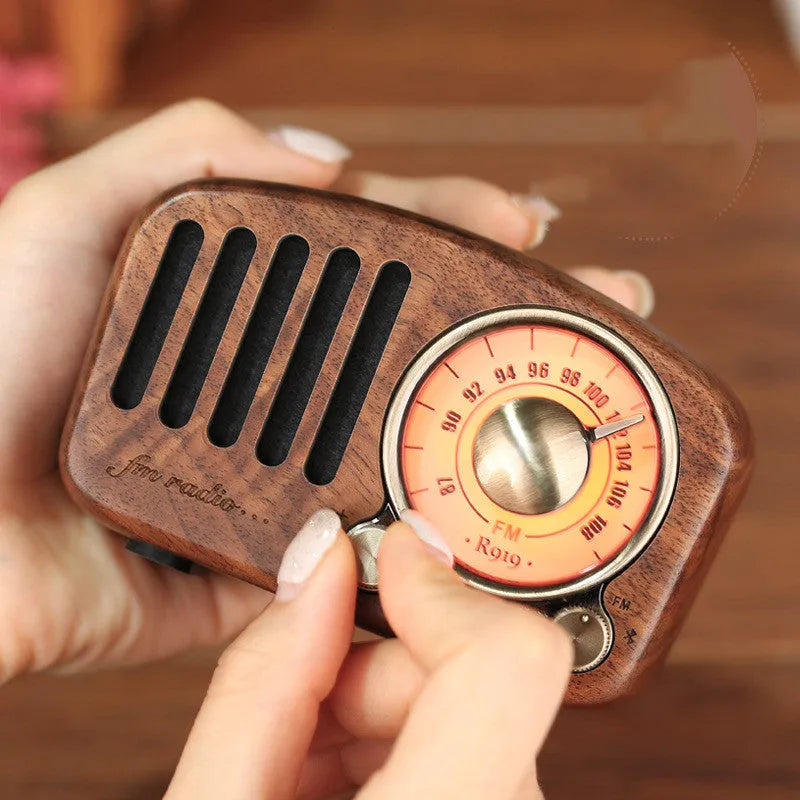 Retro wooden wireless mini speaker in cherry wood finish showing front grille and compact size