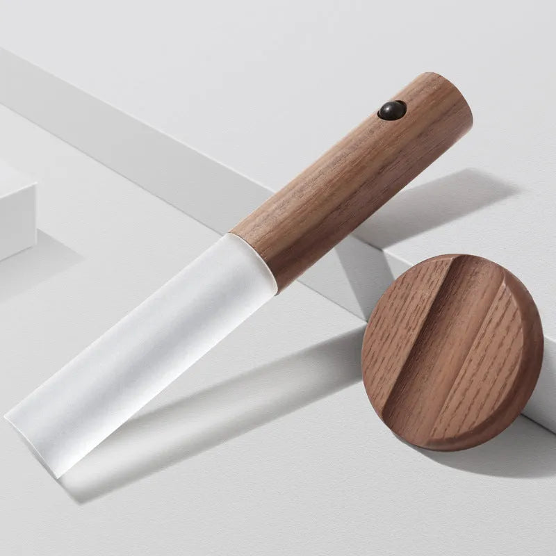 Smart sensor LED desk lamp in wood and glass, showing compact size and warm white light.