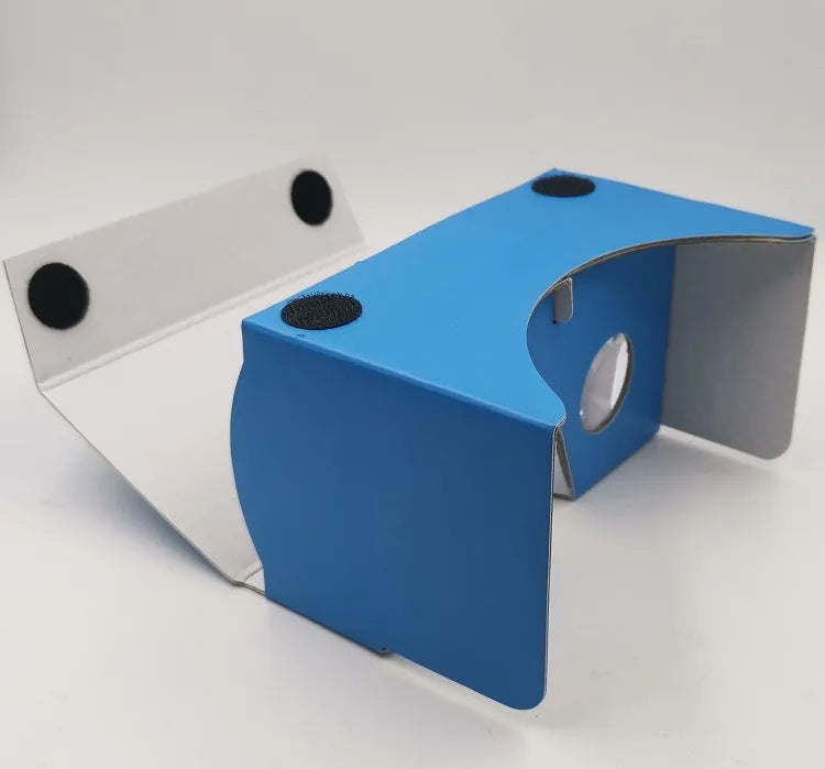 Pink and white folding cardboard VR glasses viewer for smartphones with 3D lenses and head strap.
