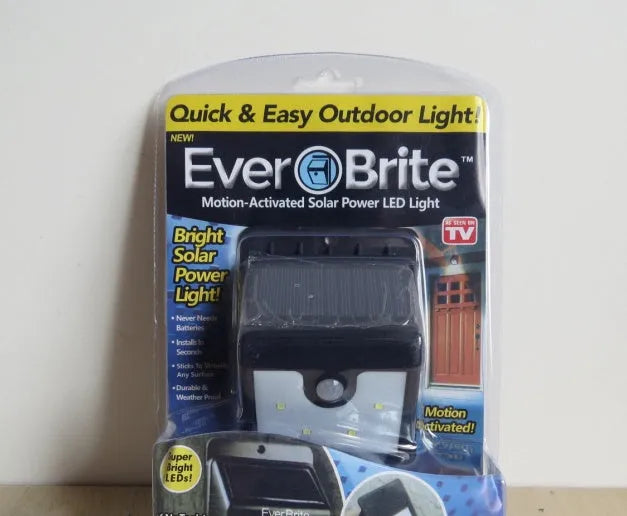 Four white solar-powered LED sensor lights for outdoor wall mounting with adjustable heads.