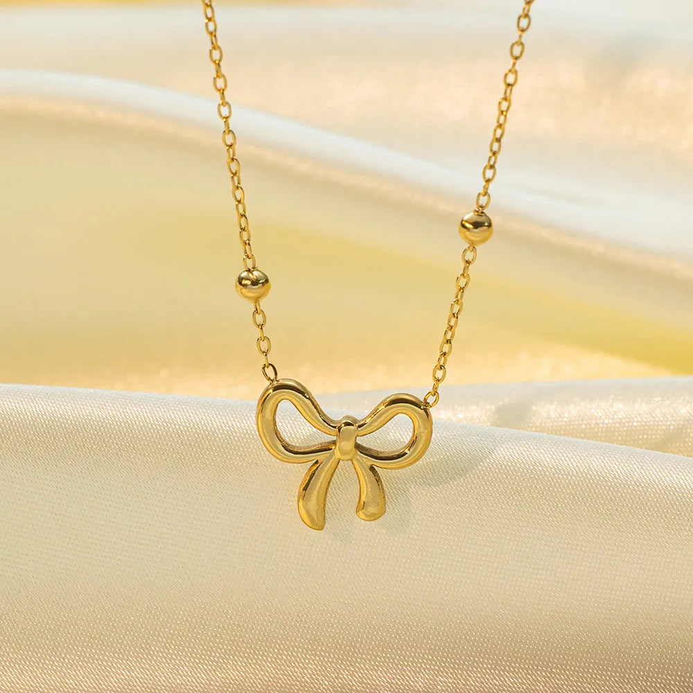 Gold titanium steel bow necklace on cross chain, adjustable 41-50 cm, for women's fashion