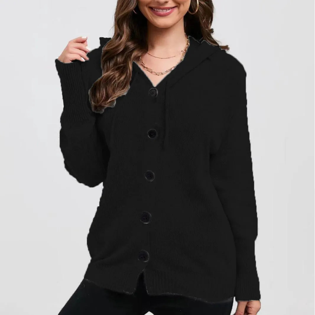 Woman wearing a thick, loose-fit grey hooded cardigan sweater with long sleeves.