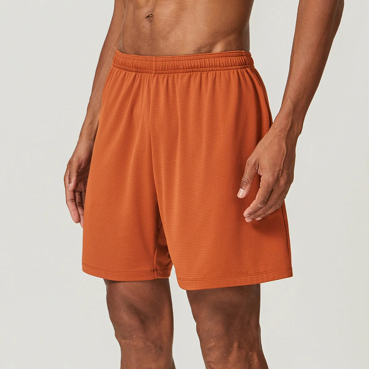 Man's quick-drying athletic shorts in khaki colour, showing double-layer construction and mid-waist fit.