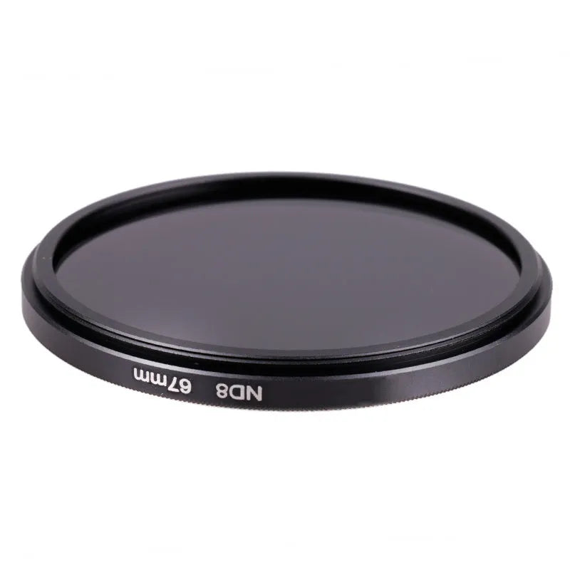 ND8 neutral density camera filter reducer with aviation aluminium frame shown next to lens.