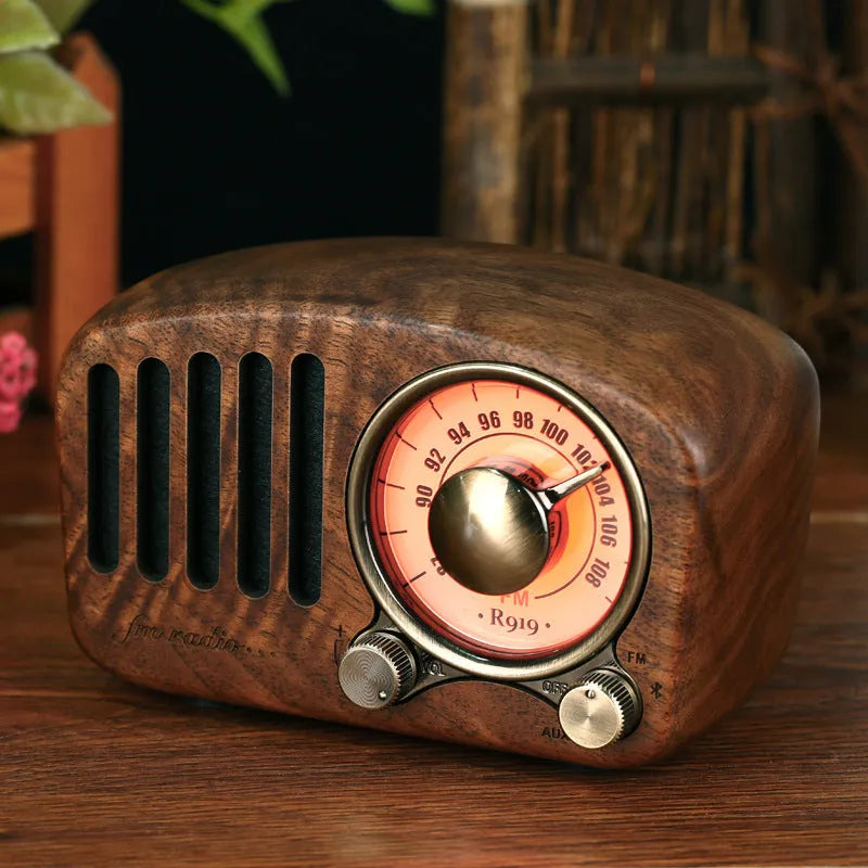 Retro wooden wireless mini speaker in cherry wood finish showing front grille and compact size