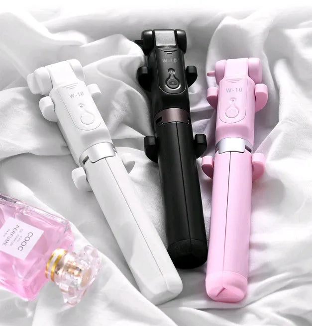 Aluminium alloy Bluetooth tripod selfie stick with remote control extended, holding a mobile phone.