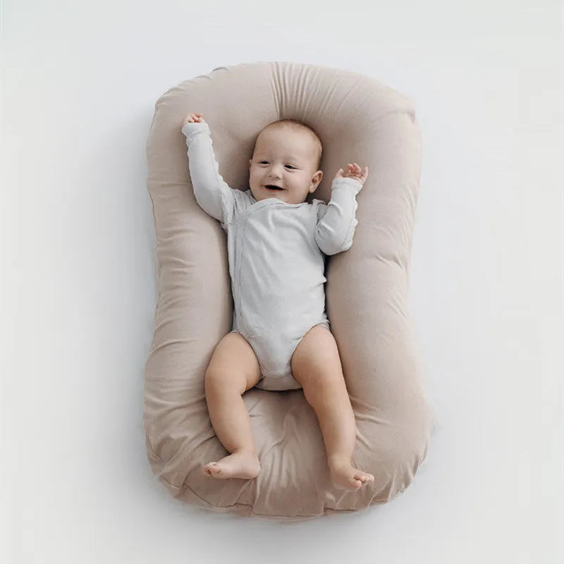 Beige portable cotton baby nest crib for newborn, measuring 75cm by 45cm.