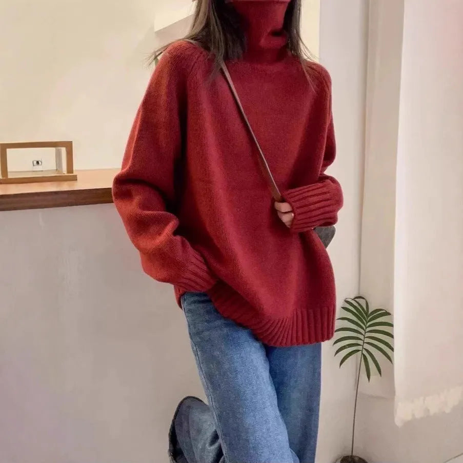 Women's loose-fit turtleneck sweater with a thick, textured curling pile collar in a grey solid colour.