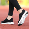 Women's running shoes in black, pink, or white with a breathable fly weave upper and wear-resistant outsole.