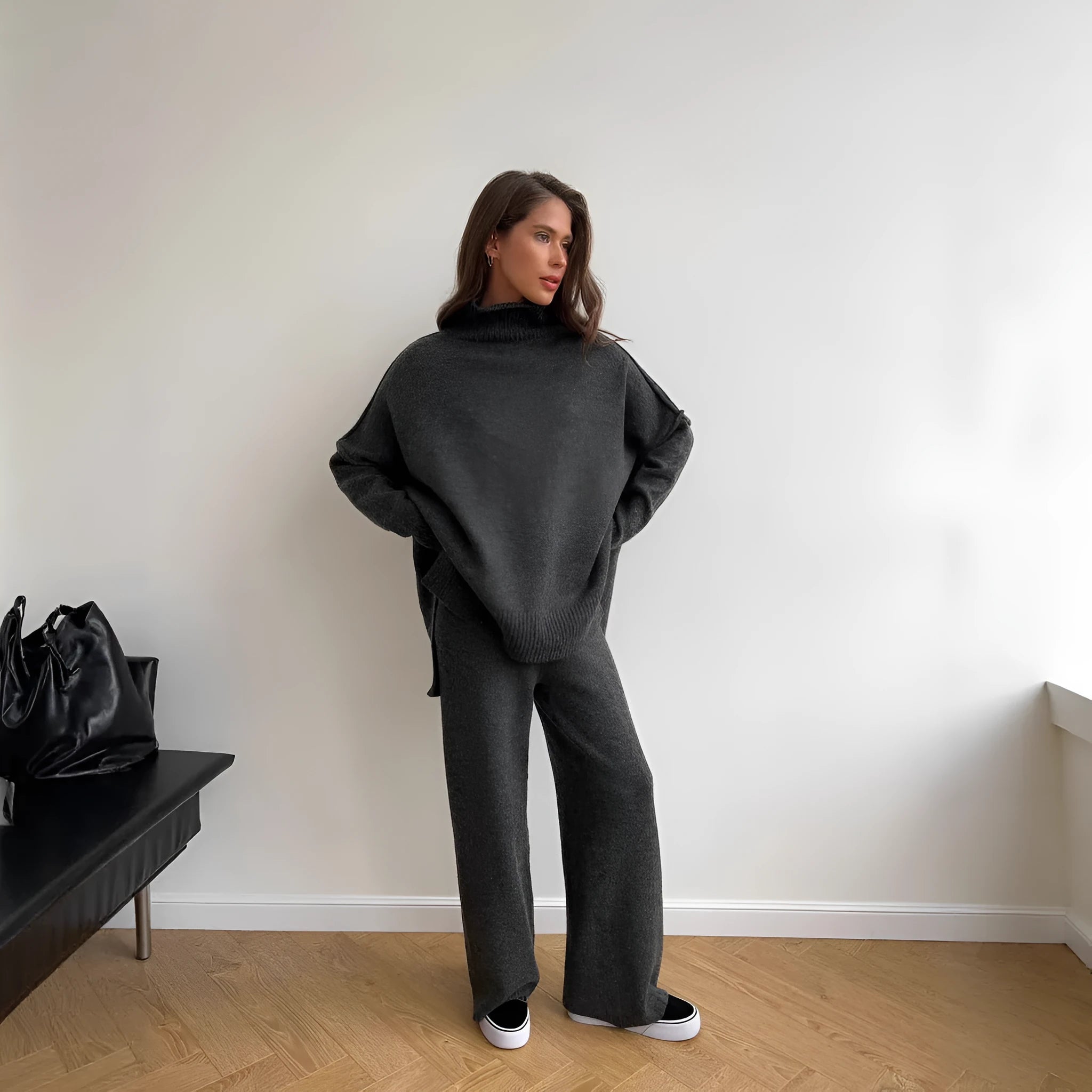 Women's dark grey side-slit sweater and trousers suit set on a hanger