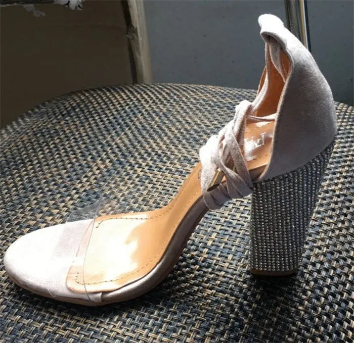 Black or gold plastic high heels with pointed toe design on size label