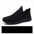 Men's black and white mesh casual sneaker with PVC sole and lace-up closure on a plain background.