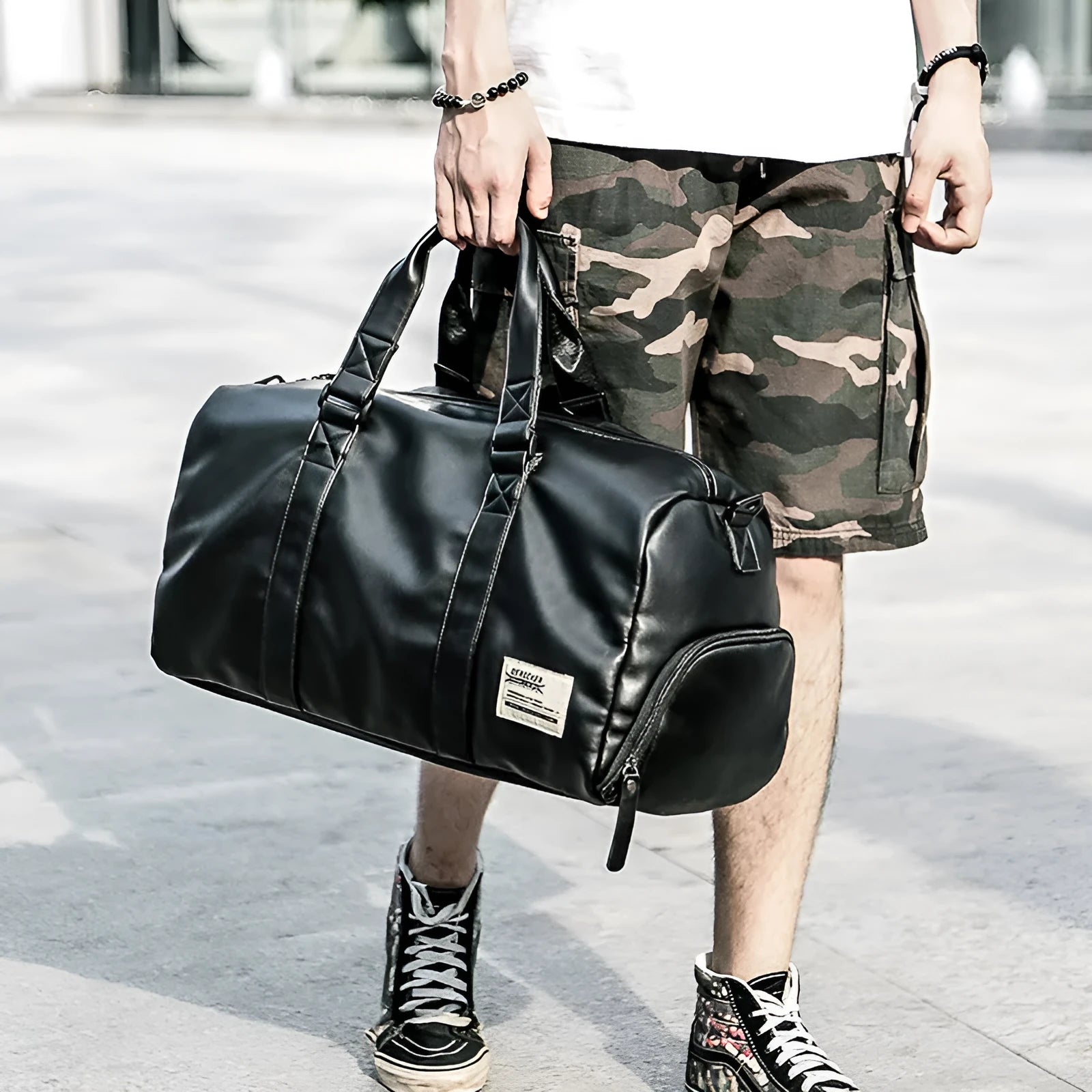 Large black waterproof PU leather sports training bag showing multiple internal organiser pockets.