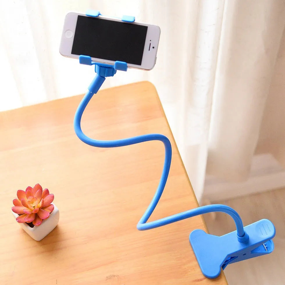 Black flexible arm phone holder with V-clip mounted on bed headboard holding smartphone