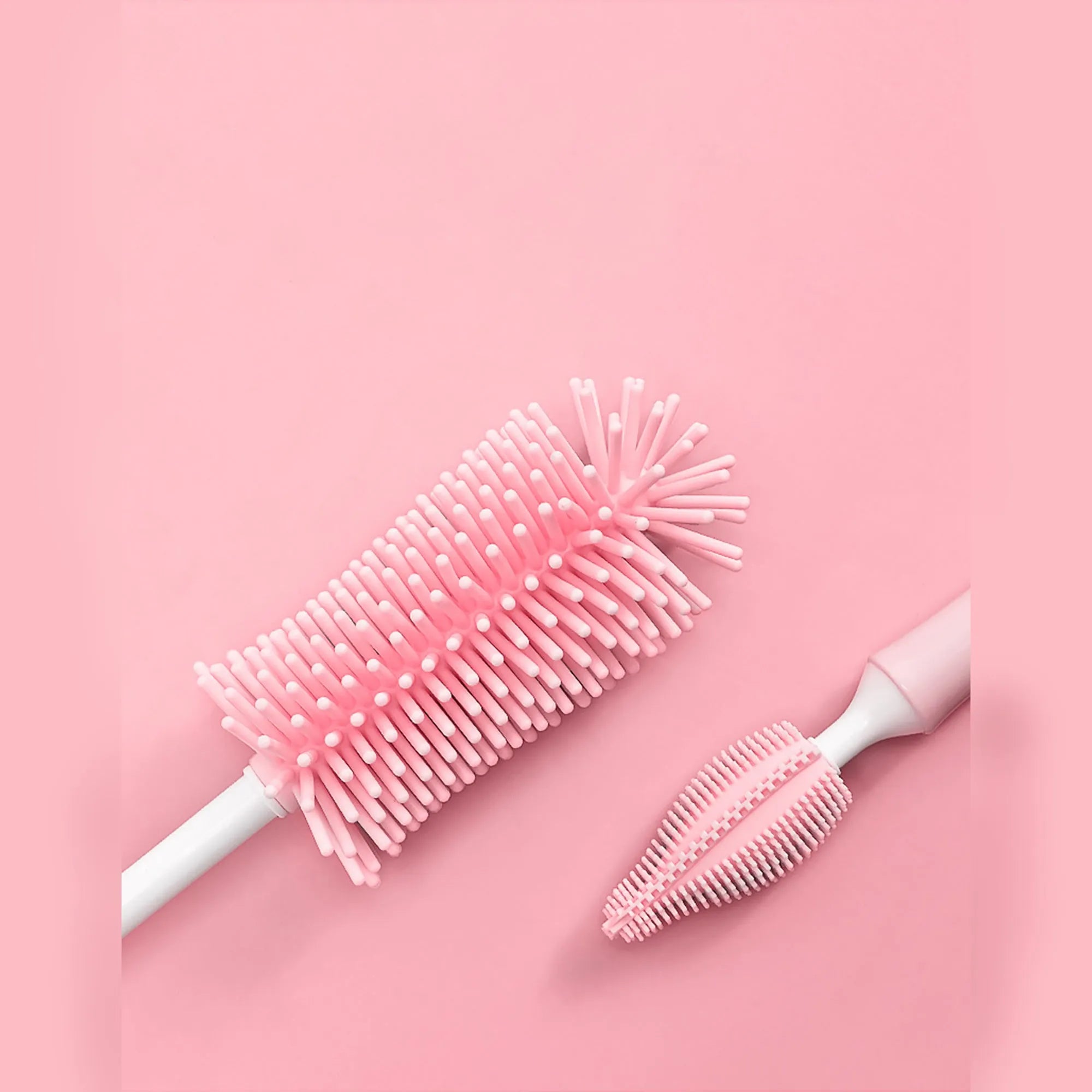 Three-piece baby bottle cleaning brush set with silicone bristles and a straw cleaner in assorted colours.