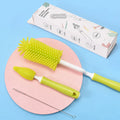 Three-piece baby bottle cleaning brush set with silicone bristles and a straw cleaner in assorted colours.