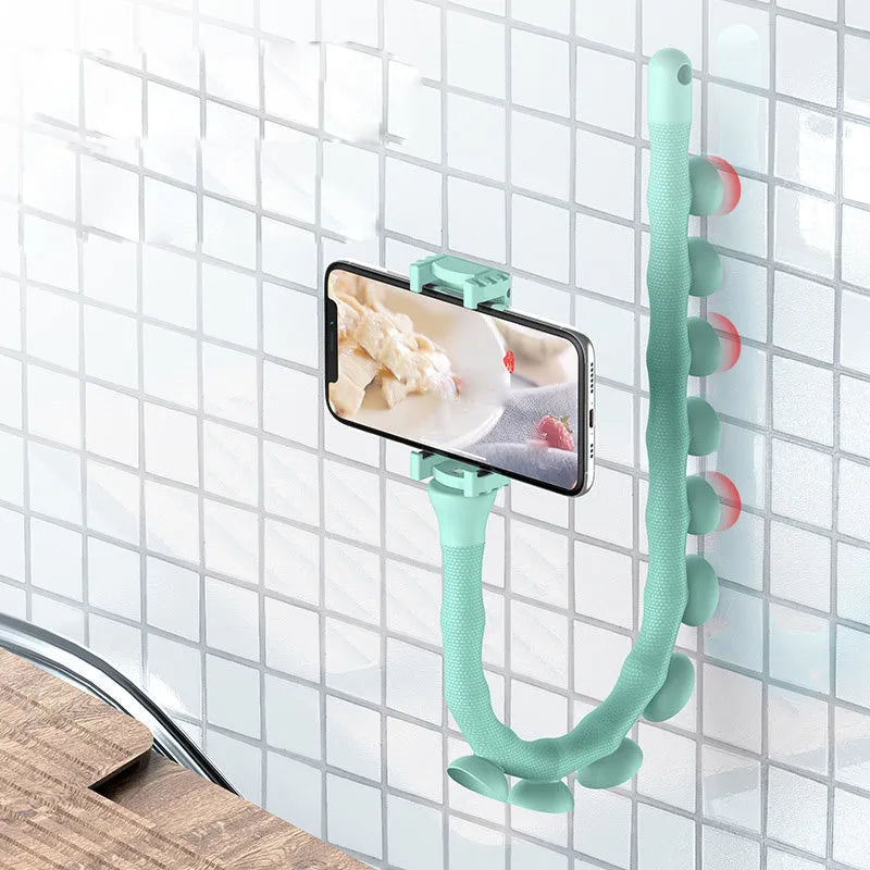 Flexible worm design mobile phone holder with suction cup mounted on desktop showing 360-degree rotation