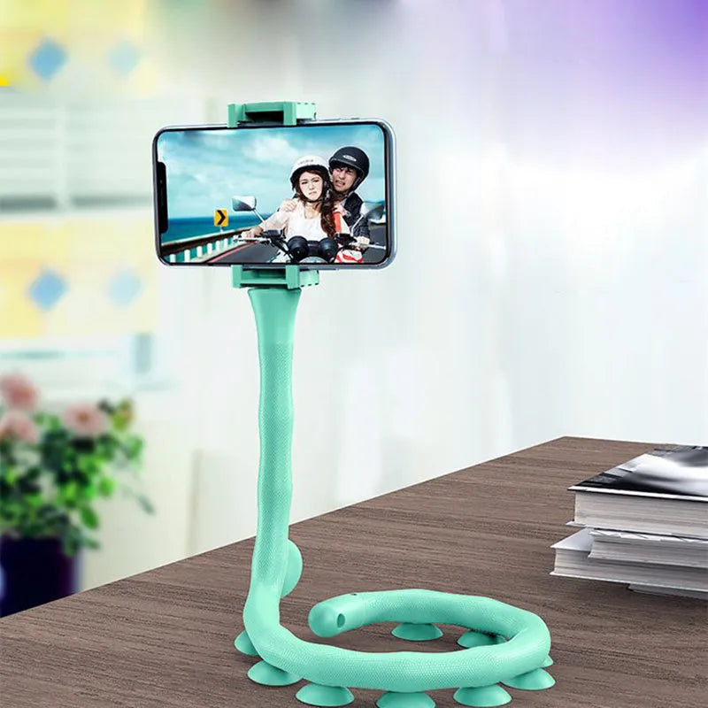 Flexible worm design mobile phone holder with suction cup mounted on desktop showing 360-degree rotation