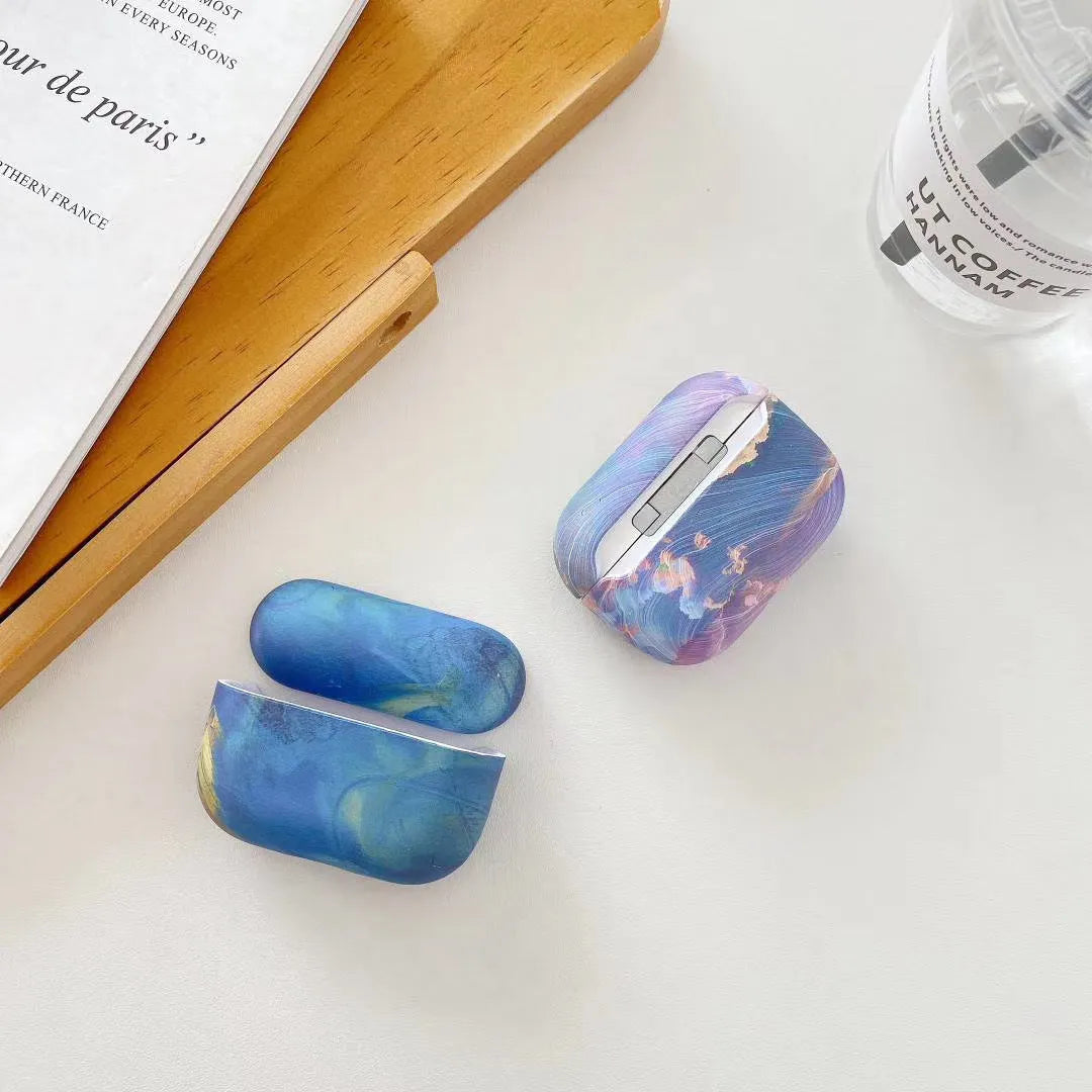 Pink and blue watercolour pattern hard plastic protective sleeve for Apple AirPods charging case.