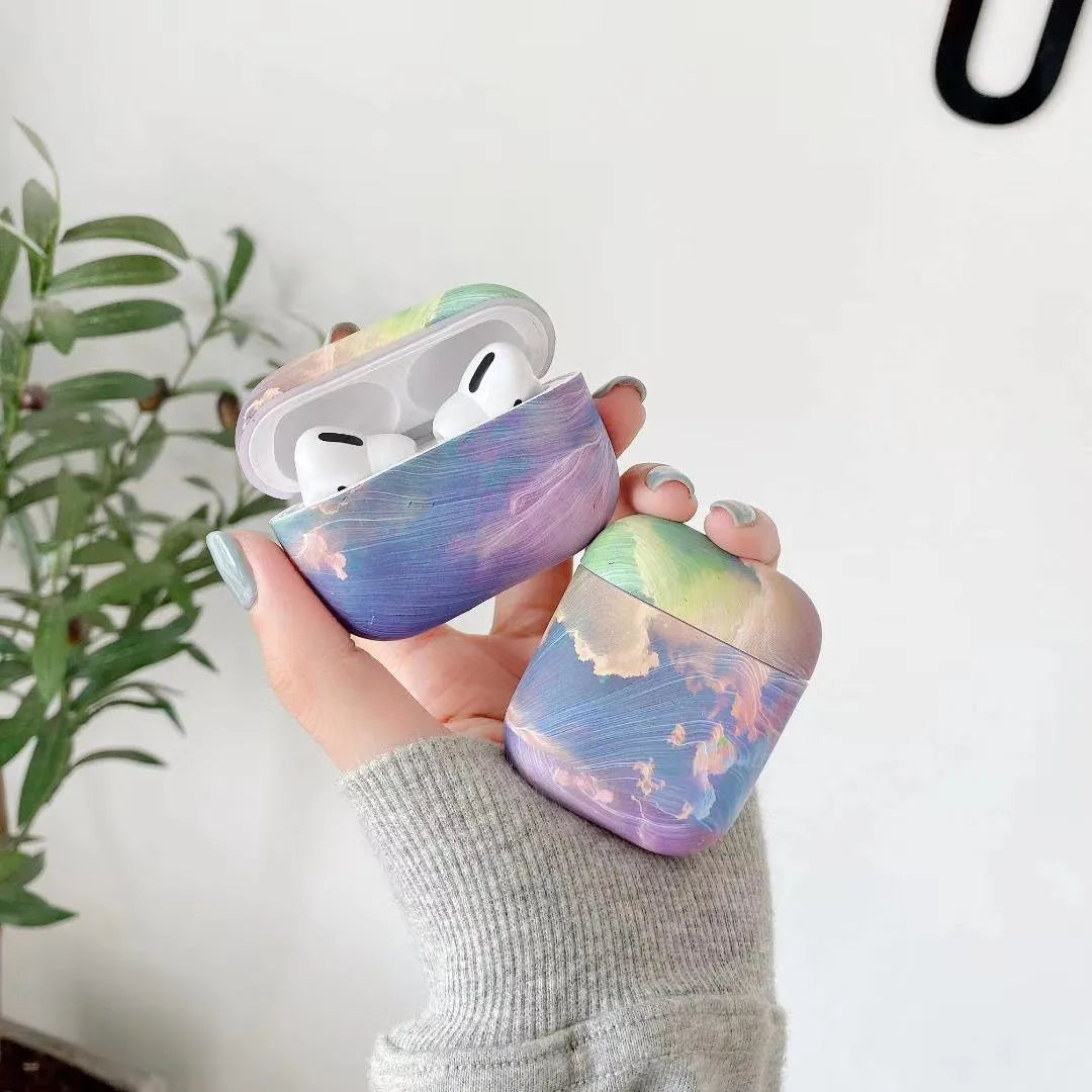 Pink and blue watercolour pattern hard plastic protective sleeve for Apple AirPods charging case.