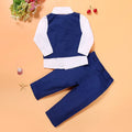 Blue boys' clothing set with turtleneck, waistcoat, tie, and trousers on a hanger.