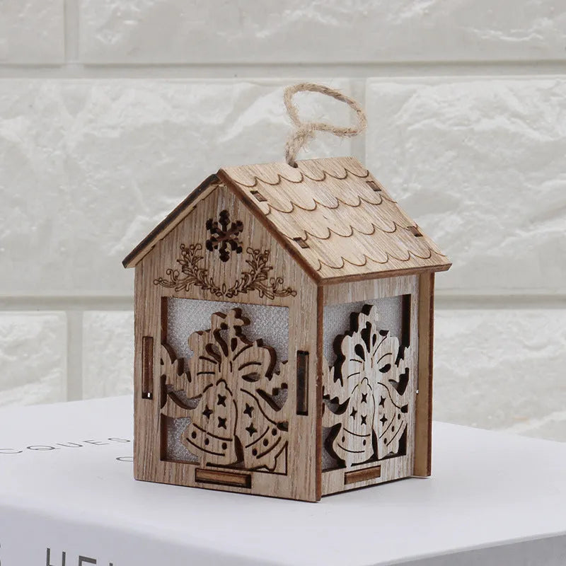 Three wooden Christmas house ornaments: small log bell, large Father Christmas house, large snowman house
