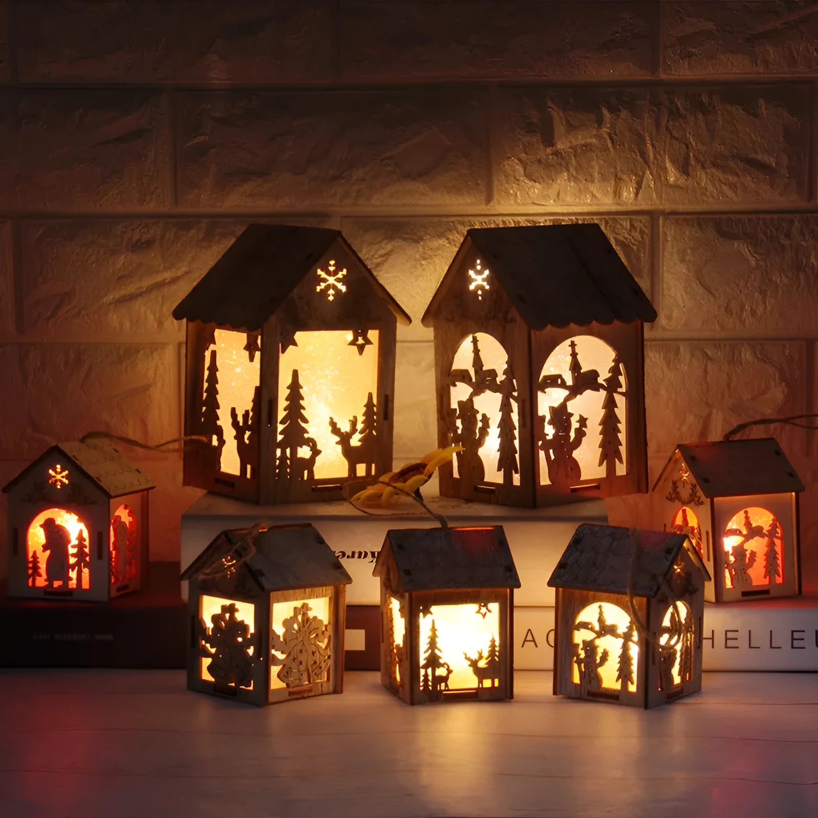 Three wooden Christmas house ornaments: small log bell, large Father Christmas house, large snowman house