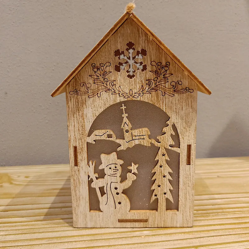 Three wooden Christmas house ornaments: small log bell, large Father Christmas house, large snowman house