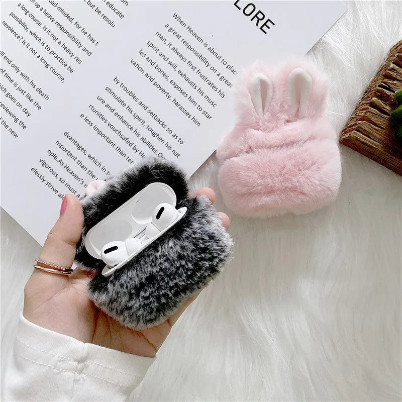 Pink silicone AirPods cover with soft plush rabbit ears decoration on charging case
