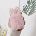 Pink silicone AirPods cover with soft plush rabbit ears decoration on charging case