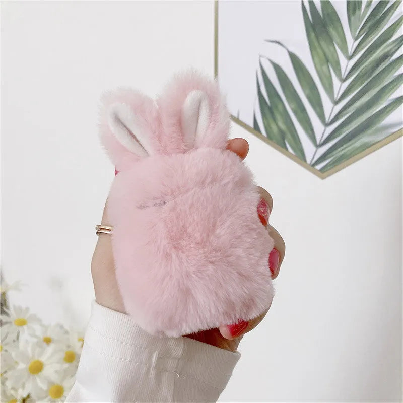 Pink silicone AirPods cover with soft plush rabbit ears decoration on charging case