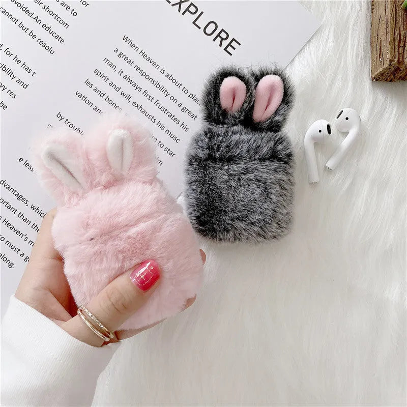 Pink silicone AirPods cover with soft plush rabbit ears decoration on charging case